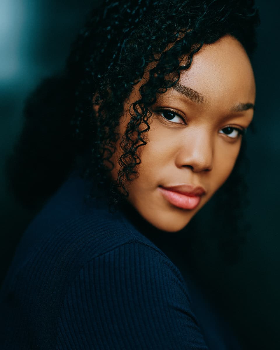 Voice actor headshot with a warm and approachable expression