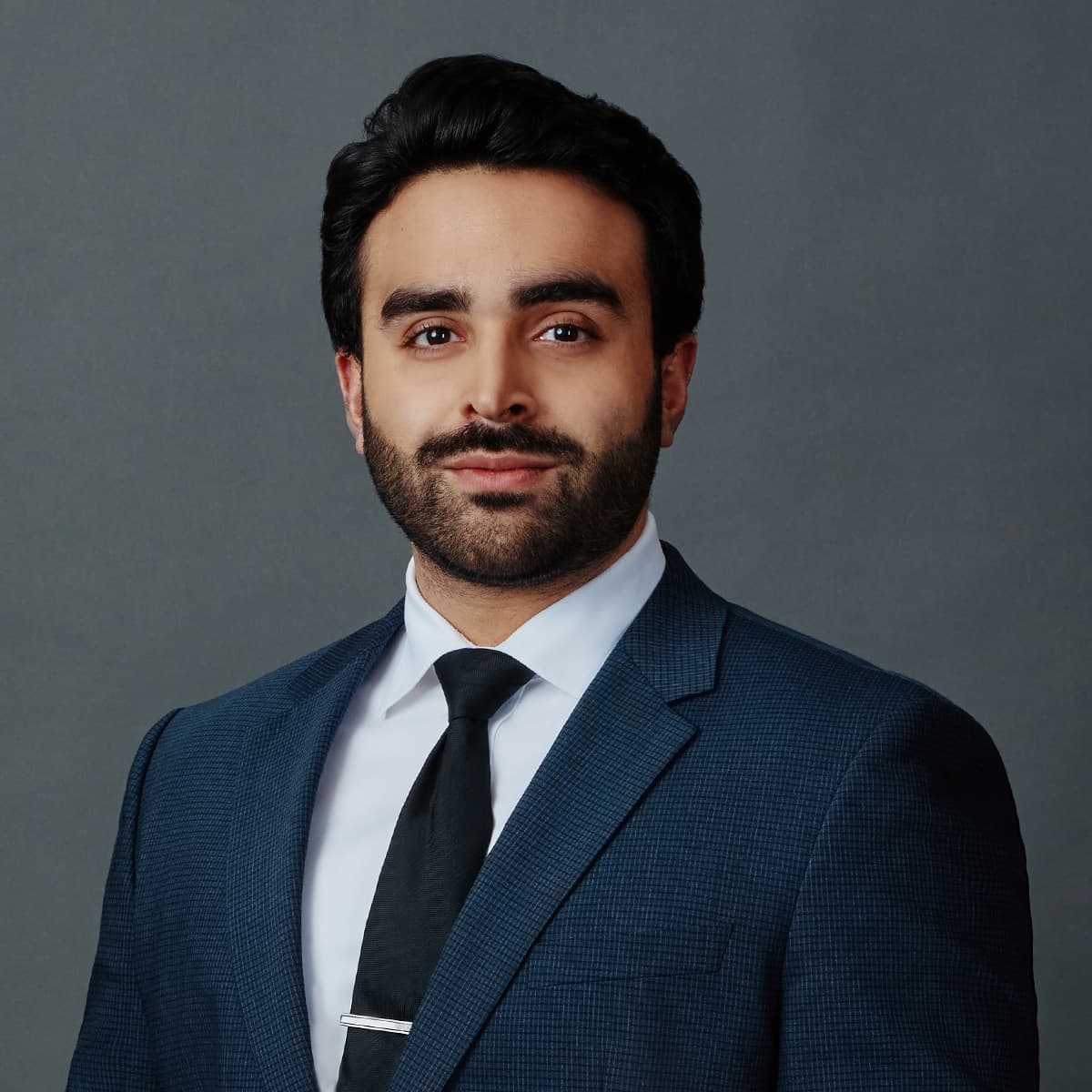 Corporate headshot man tie formal dark backdrop