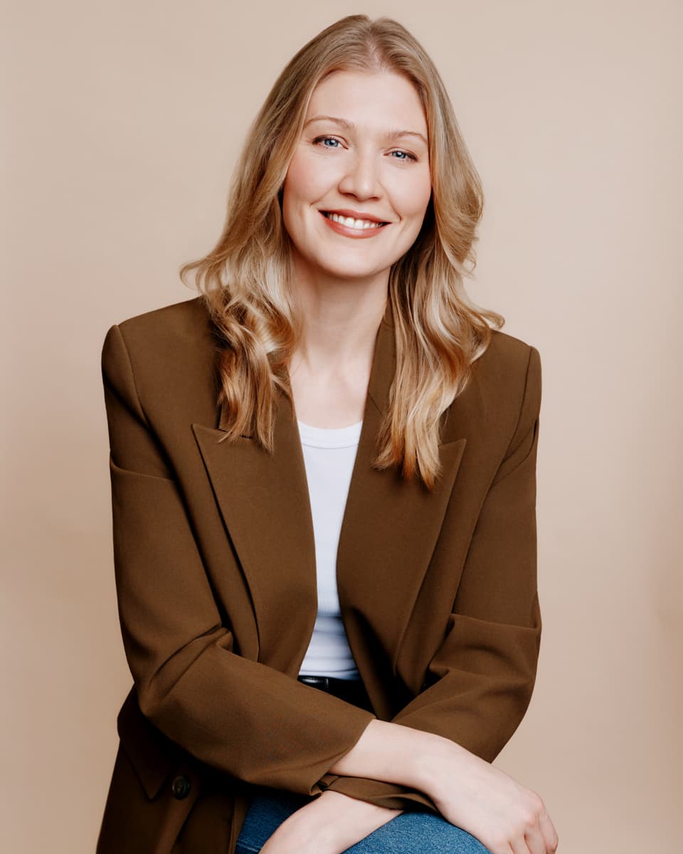 Professional headshot woman grey backdrop