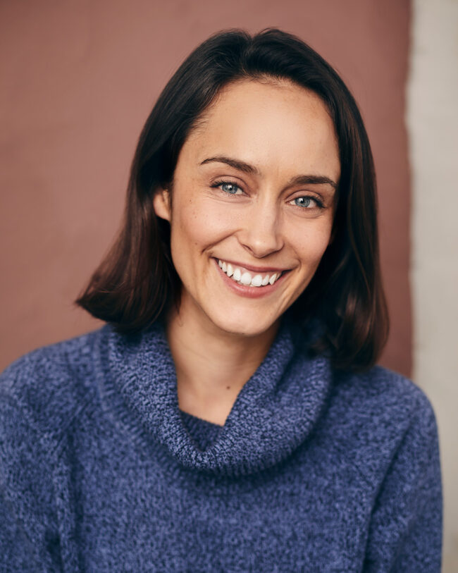 smiling actress with turtleneck
