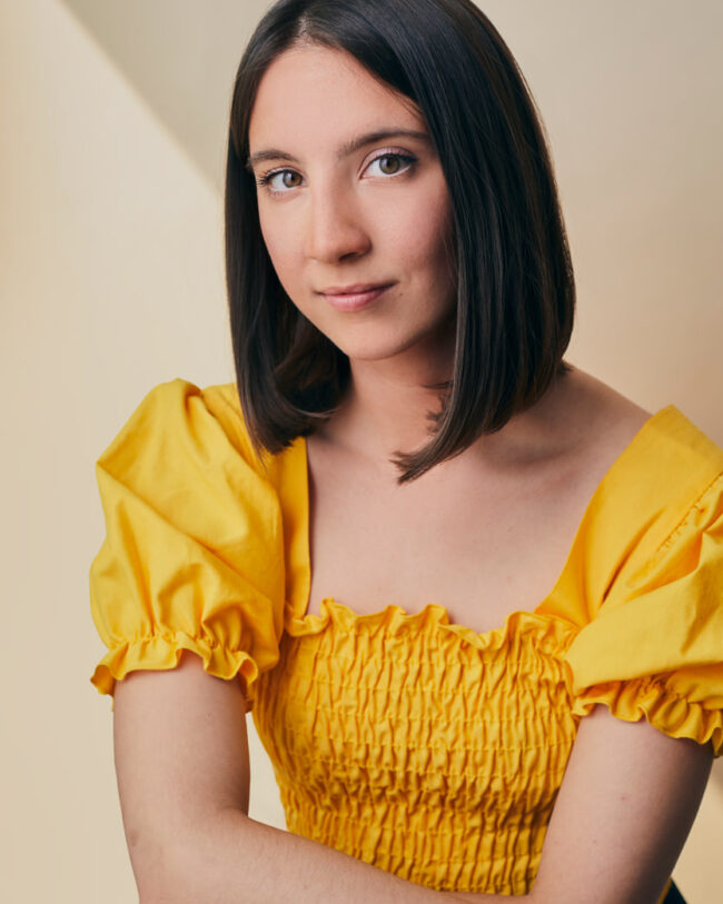 young woman wearing yellow blouse