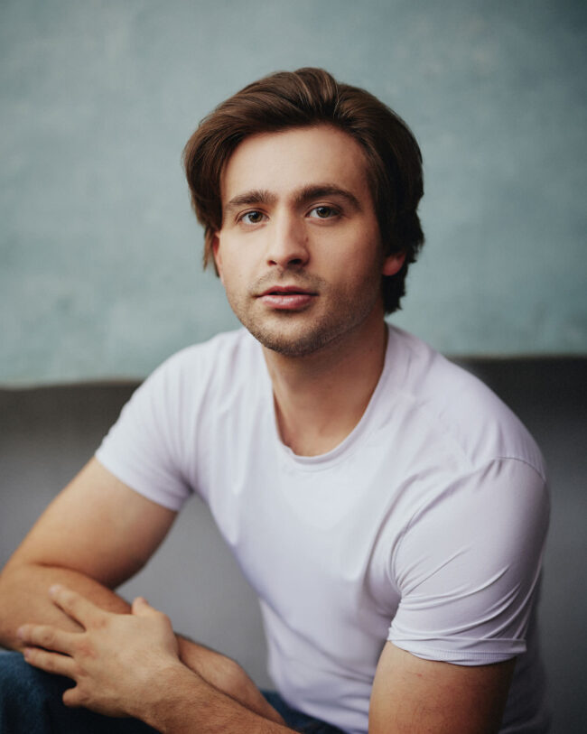 actor siting in a white t-shirt