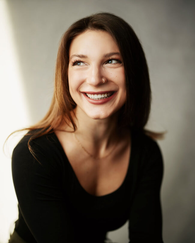 Portrait of a woman smiling looking off camera