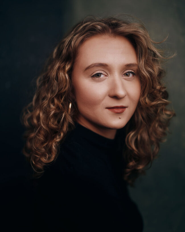 Woman with curly hair sitting for a portrait
